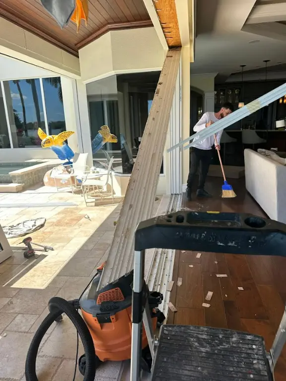 Demonstration of a worn pocket door track showing damage from incorrect roller installation